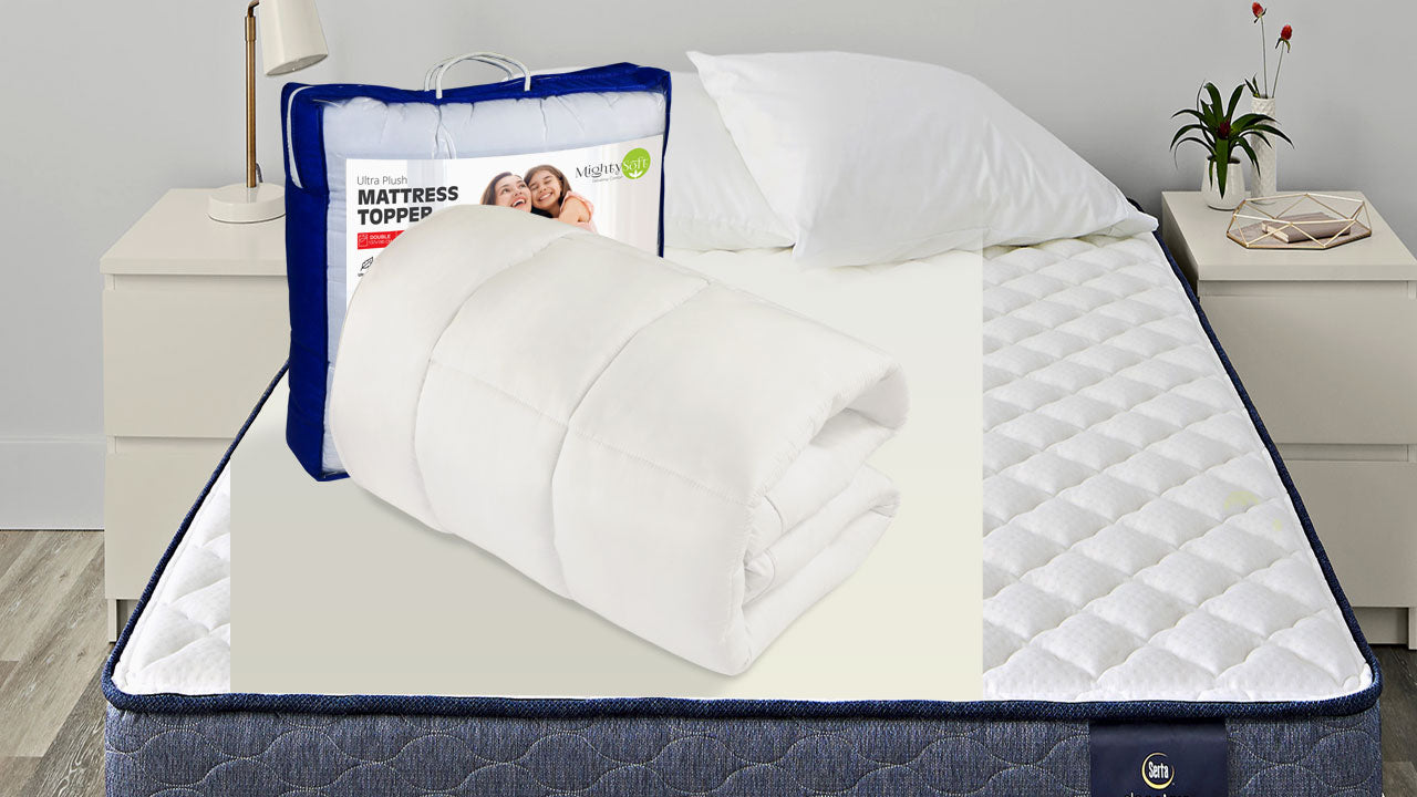 MightySoft mattress topper is placed on the bed with packaging
