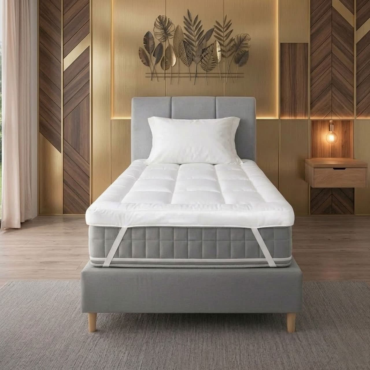 Gray bed frame with white mattress and pillow in a bedroom setting.
