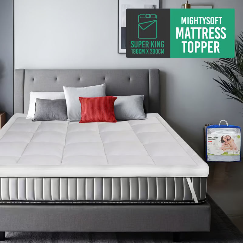 White mattress topper on a bed with pillows