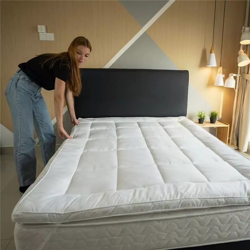 A luxury king size mattress topper installed in a modern master bedroom to revitalize an ageing mattress.