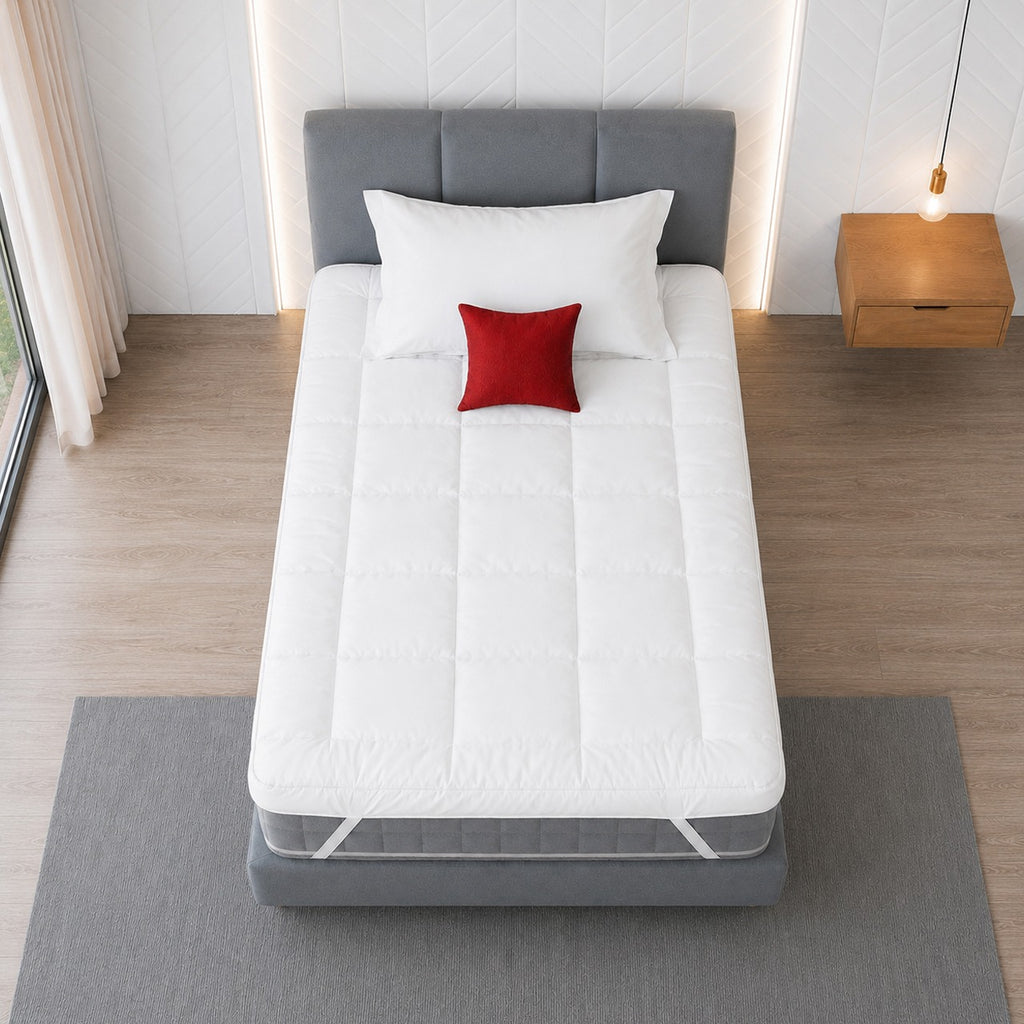 top view of a luxurious white mattress topper on a single size bed