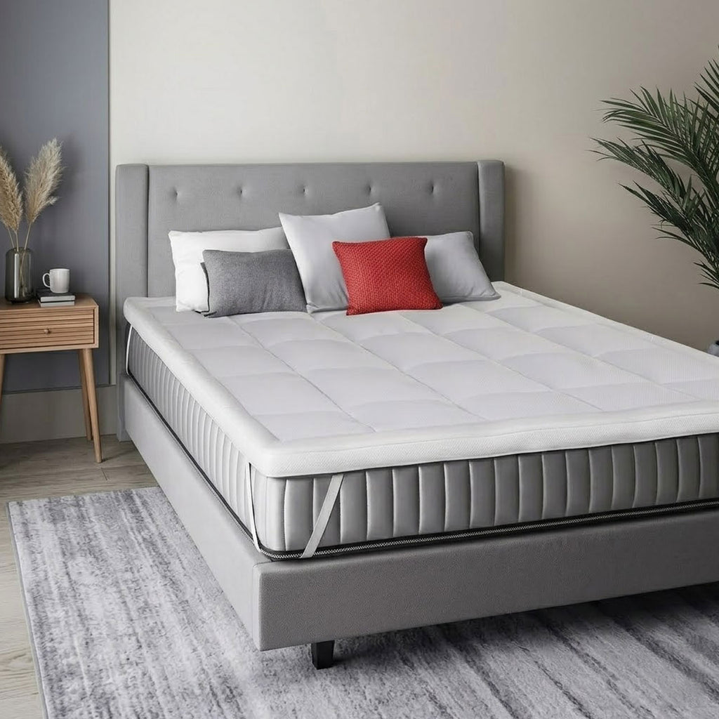 Gray bed with white mattress and pillows in a bedroom setting